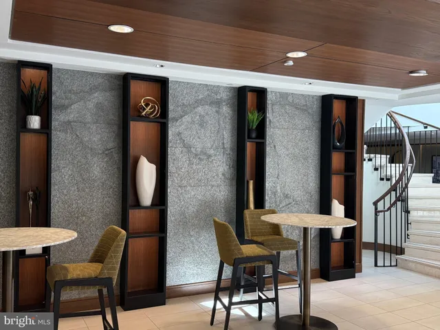 a view of a patio with table and chairs and potted plants