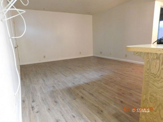 712 North Florence Street Ridgecrest, CA 93555 - Photo 9 of 14 a view of a room with wooden floor and windows
