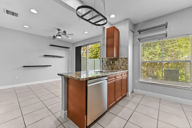 a kitchen with stainless steel appliances granite countertop a stove a sink and a refrigerator