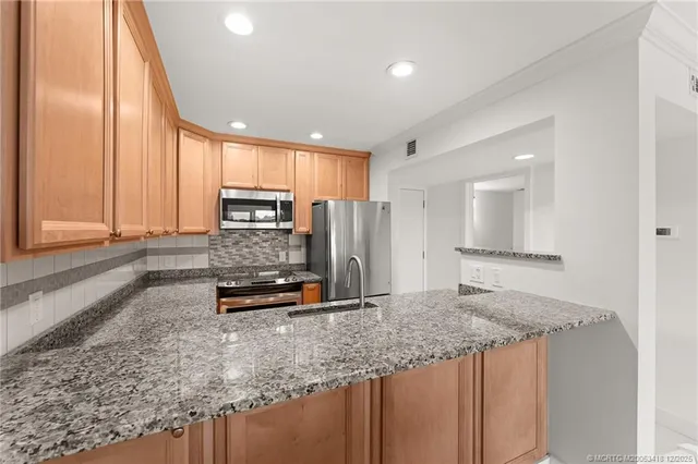 a kitchen with a sink stove and refrigerator