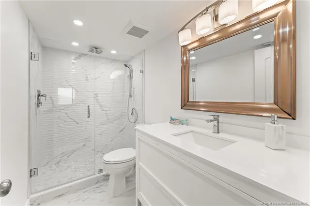 a bathroom with a toilet a sink and a mirror