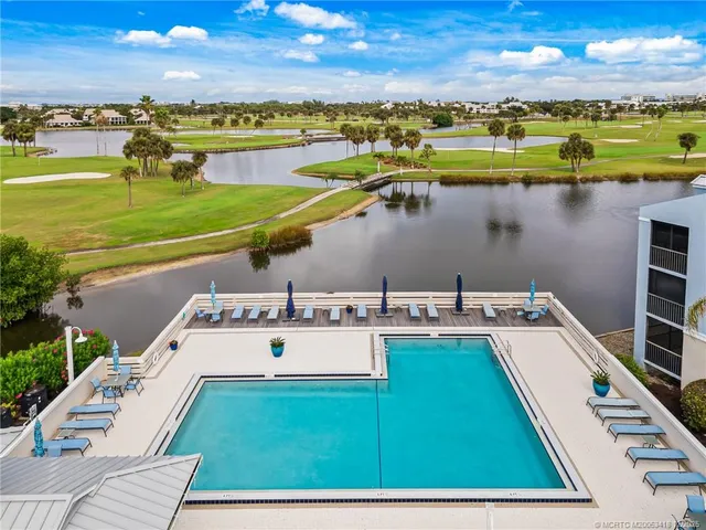 a view of a swimming pool with a table and chairs
