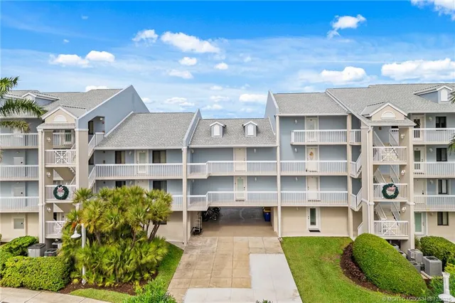 a front view of a building with a garden