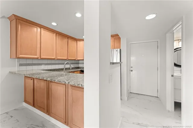 a kitchen with a stove a sink and cabinets