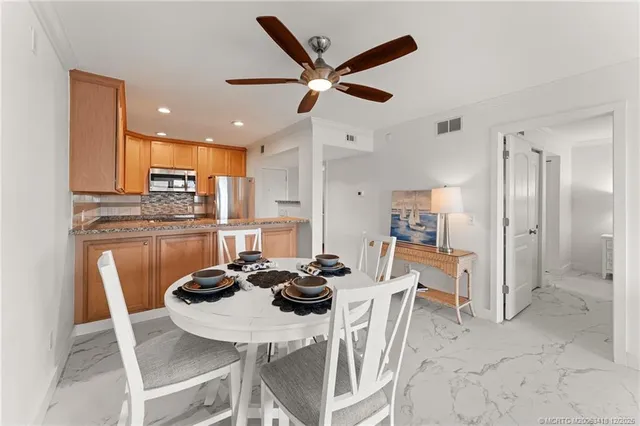 a view of a livingroom with furniture and a ceiling fan
