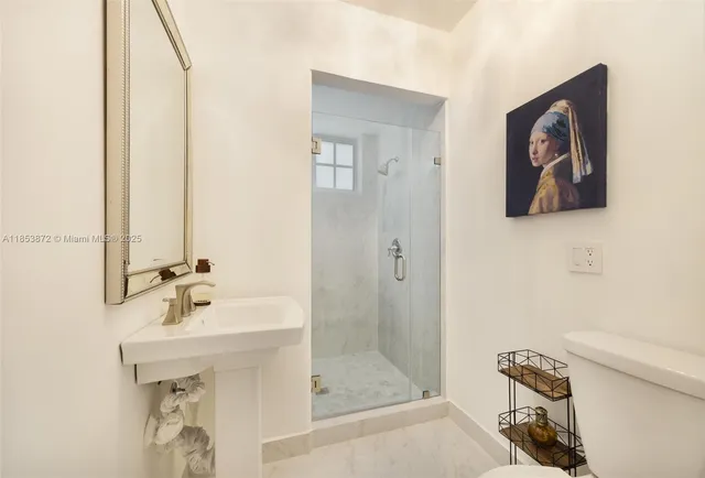 a bathroom with a sink a mirror and a shower