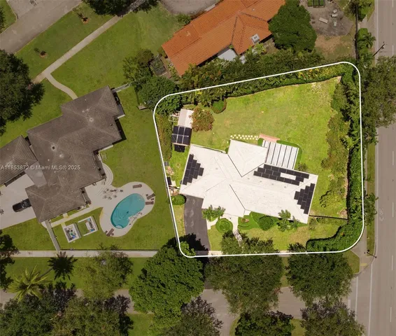 an aerial view of a house with a swimming pool