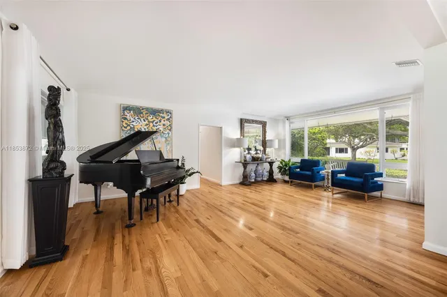 a view of living room filled with furniture and wooden floor