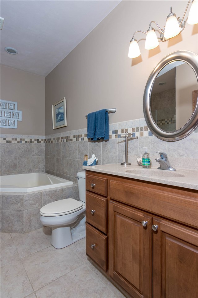 12019 Patterson Road Durand, IL 61024 - Photo 18 of 25 a bathroom with a toilet a sink and a mirror