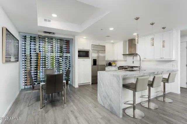 a kitchen with a table chairs refrigerator and wooden cabinets