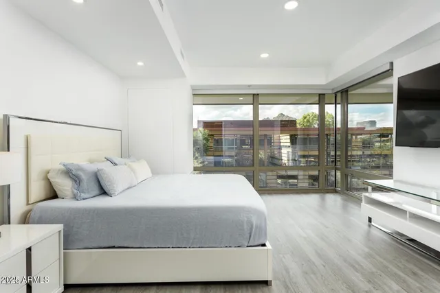 a bedroom with a large bed and a large window