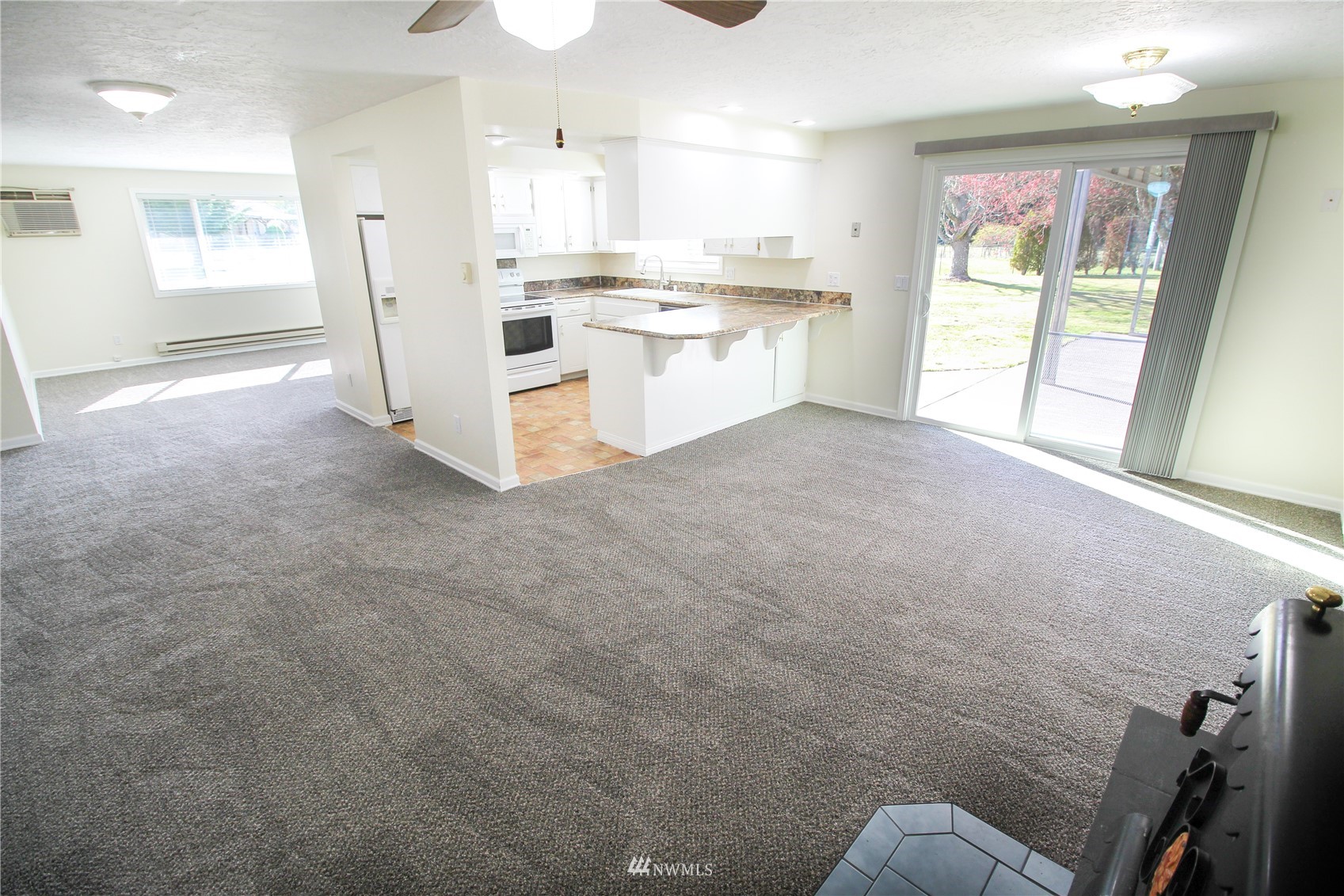 18245 Cinnamon Lane Southwest Rochester, WA 98579 - Photo 3 of 22 a open kitchen with white cabinets and white appliances