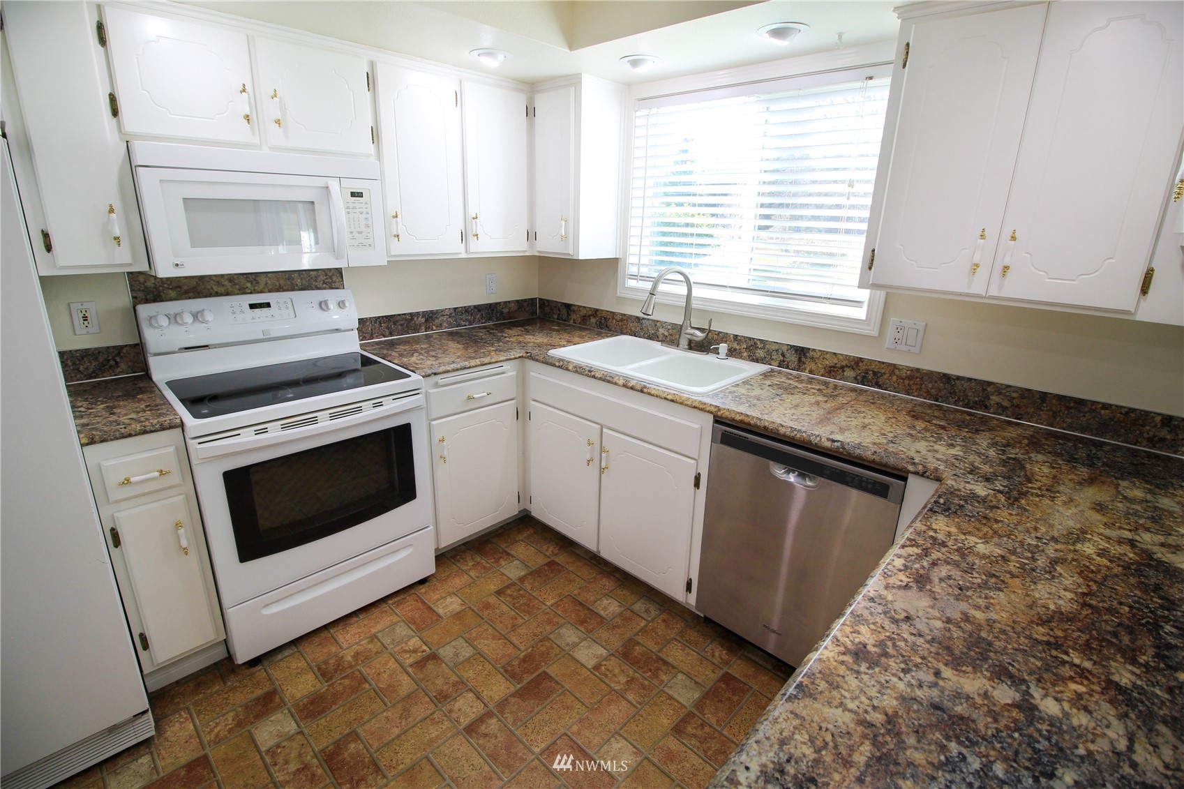 18245 Cinnamon Lane Southwest Rochester, WA 98579 - Photo 7 of 22 a kitchen with granite countertop white cabinets and white appliances