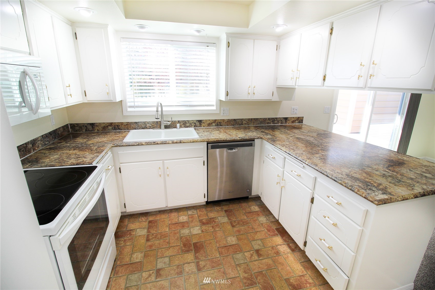 18245 Cinnamon Lane Southwest Rochester, WA 98579 - Photo 8 of 22 a kitchen with granite countertop white cabinets and white appliances