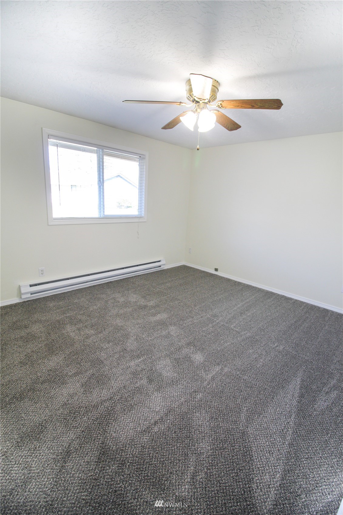 18245 Cinnamon Lane Southwest Rochester, WA 98579 - Photo 9 of 22 an empty room with windows and fan