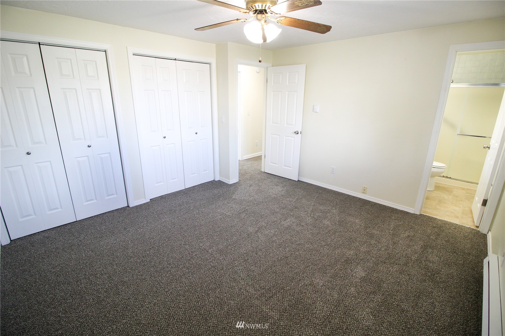 18245 Cinnamon Lane Southwest Rochester, WA 98579 - Photo 10 of 22 an empty room with a ceiling fan and a window