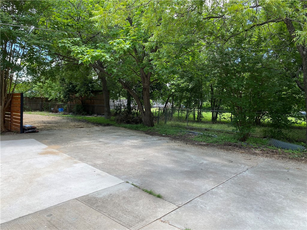 a view of a park with large trees