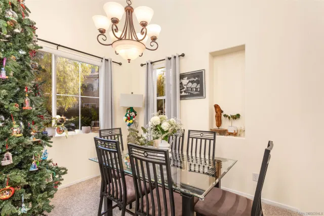 a kitchen with a table chairs and flat screen tv