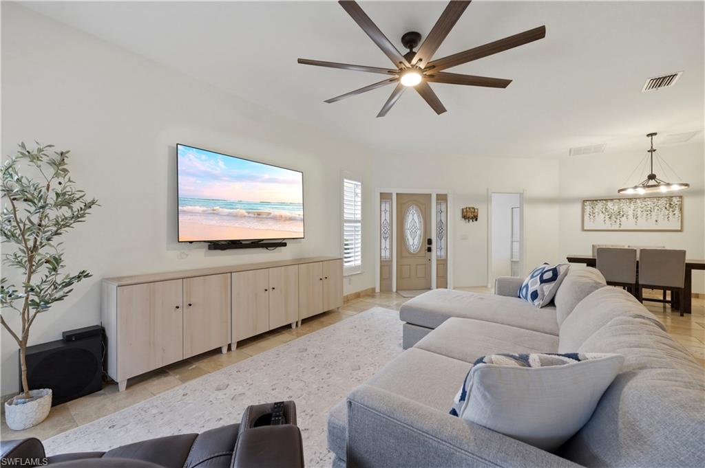 415 Crossfield Circle, Unit 81 Naples, FL 34104 - Photo 11 of 33 a living room with furniture a flat screen tv and a ceiling fan