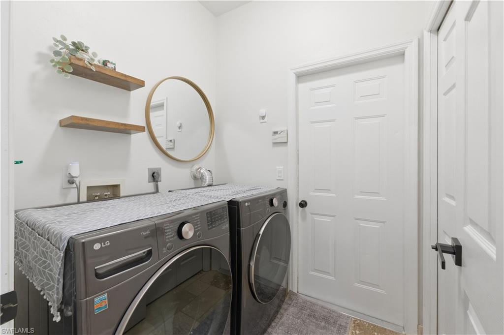 415 Crossfield Circle, Unit 81 Naples, FL 34104 - Photo 12 of 33 a bathroom with a granite countertop sink and a mirror