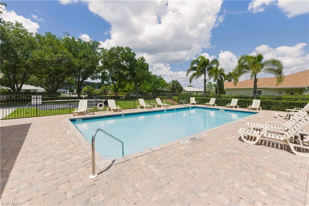 415 Crossfield Circle, Unit 81 Naples, FL 34104 - Photo 18 of 33 a view of swimming pool with a yard and sitting area