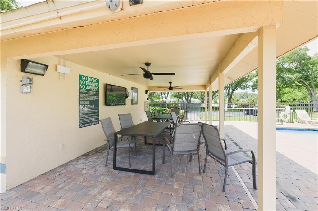 415 Crossfield Circle, Unit 81 Naples, FL 34104 - Photo 19 of 33 a dining room with furniture and a floor to ceiling window