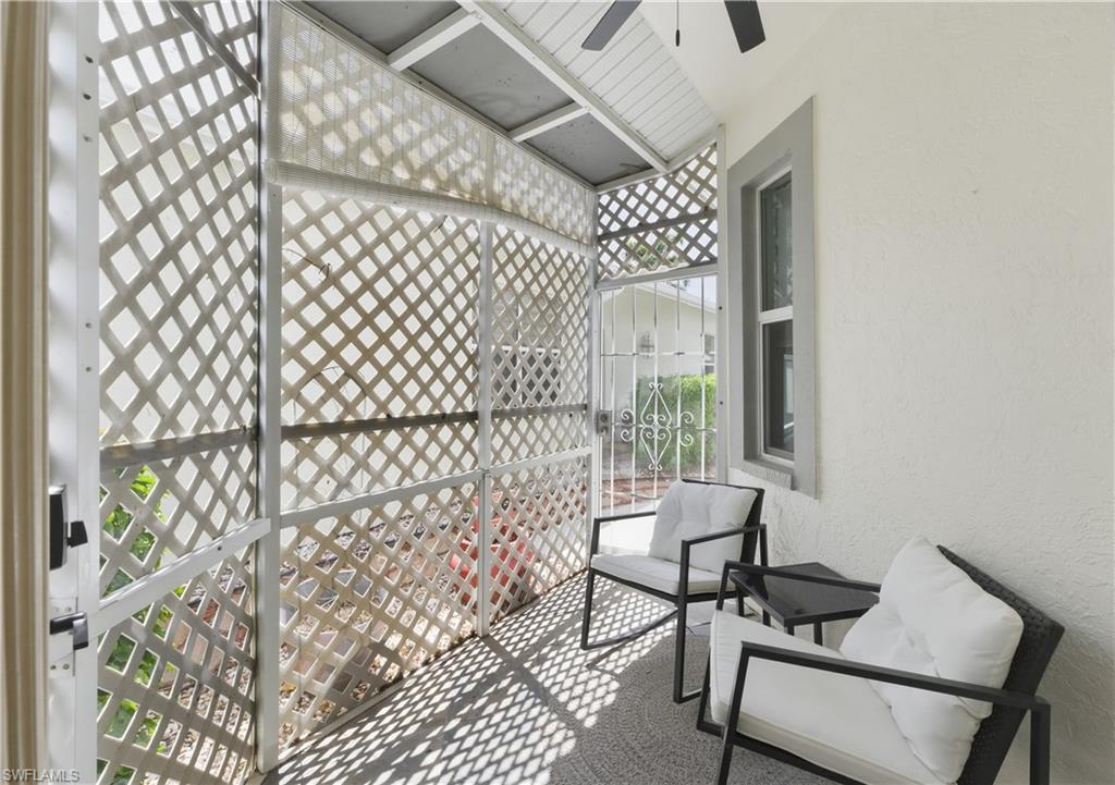 415 Crossfield Circle, Unit 81 Naples, FL 34104 - Photo 22 of 33 a bedroom with a bed and a chair