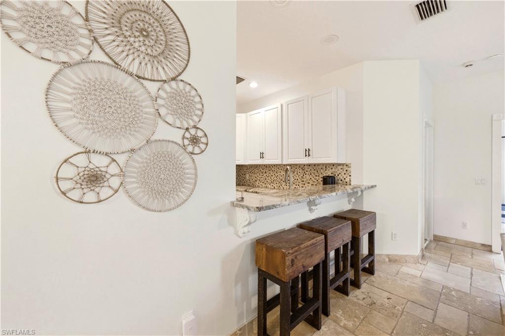 415 Crossfield Circle, Unit 81 Naples, FL 34104 - Photo 26 of 33 a kitchen with a table and chairs in it