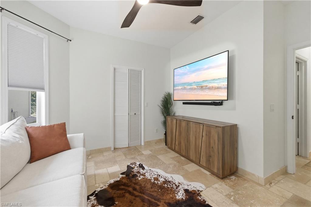 415 Crossfield Circle, Unit 81 Naples, FL 34104 - Photo 29 of 33 a living room with furniture and a flat screen tv