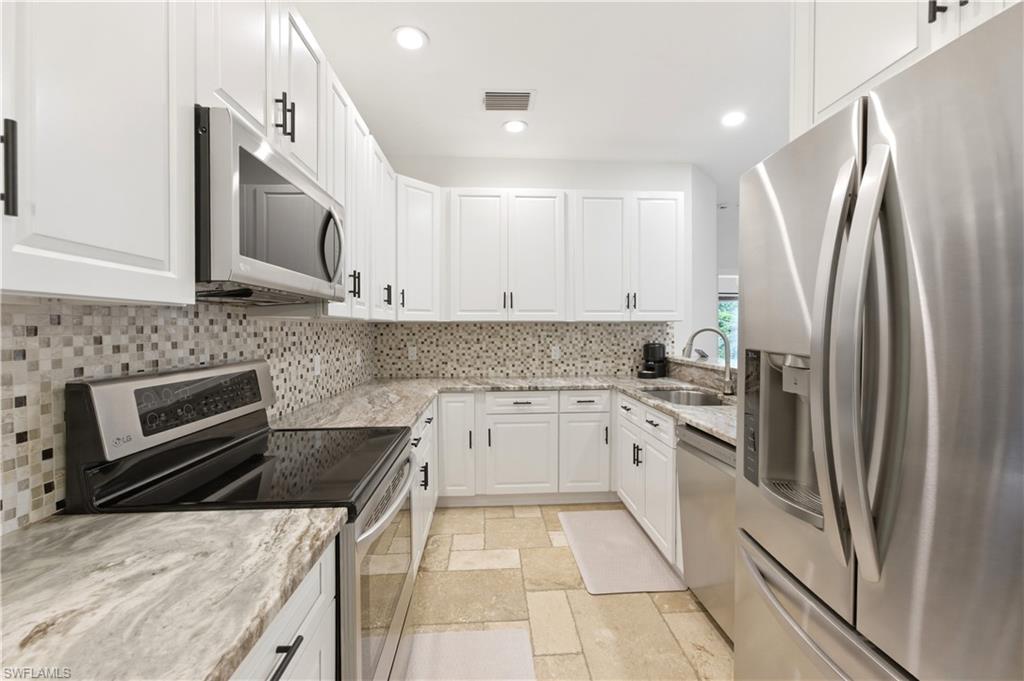 415 Crossfield Circle, Unit 81 Naples, FL 34104 - Photo 3 of 33 a kitchen with a sink stove and refrigerator