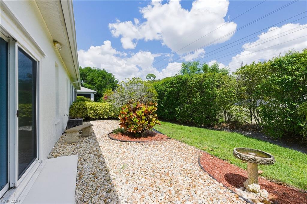 415 Crossfield Circle, Unit 81 Naples, FL 34104 - Photo 32 of 33 a view of a backyard with couches and potted plants