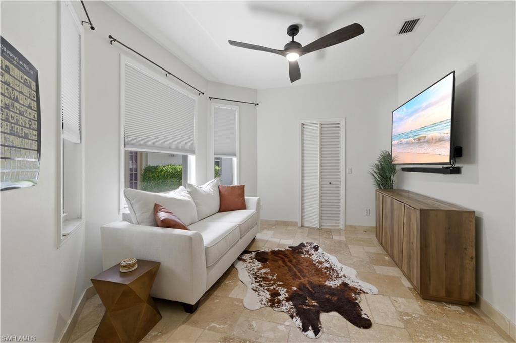415 Crossfield Circle, Unit 81 Naples, FL 34104 - Photo 7 of 33 a living room with furniture and a flat screen tv
