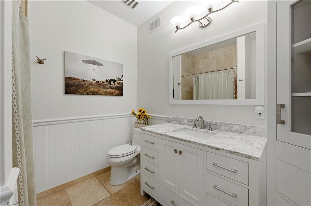 415 Crossfield Circle, Unit 81 Naples, FL 34104 - Photo 10 of 33 a bathroom with a granite countertop sink a toilet and a mirror