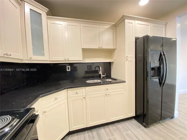 a kitchen with stainless steel appliances a refrigerator a stove top oven a sink and dishwasher