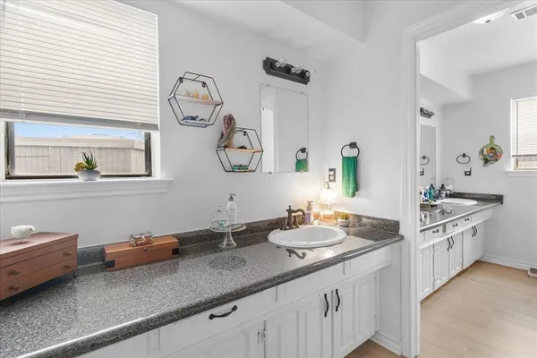 a bathroom with a double vanity sink and a mirror