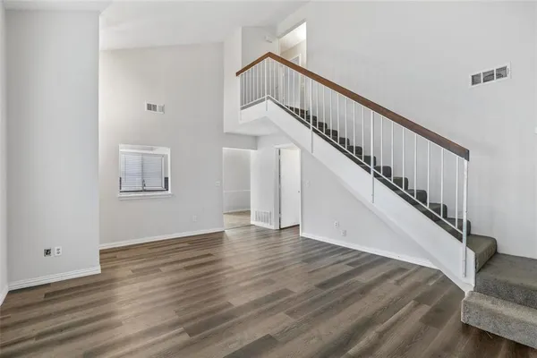 a view of entryway and hall with wooden floor