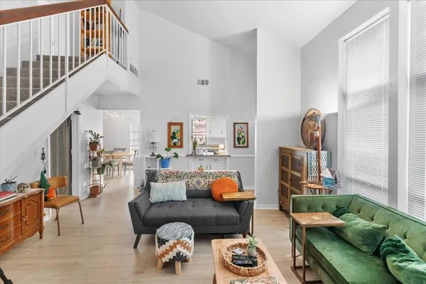 a living room with furniture and wooden floor
