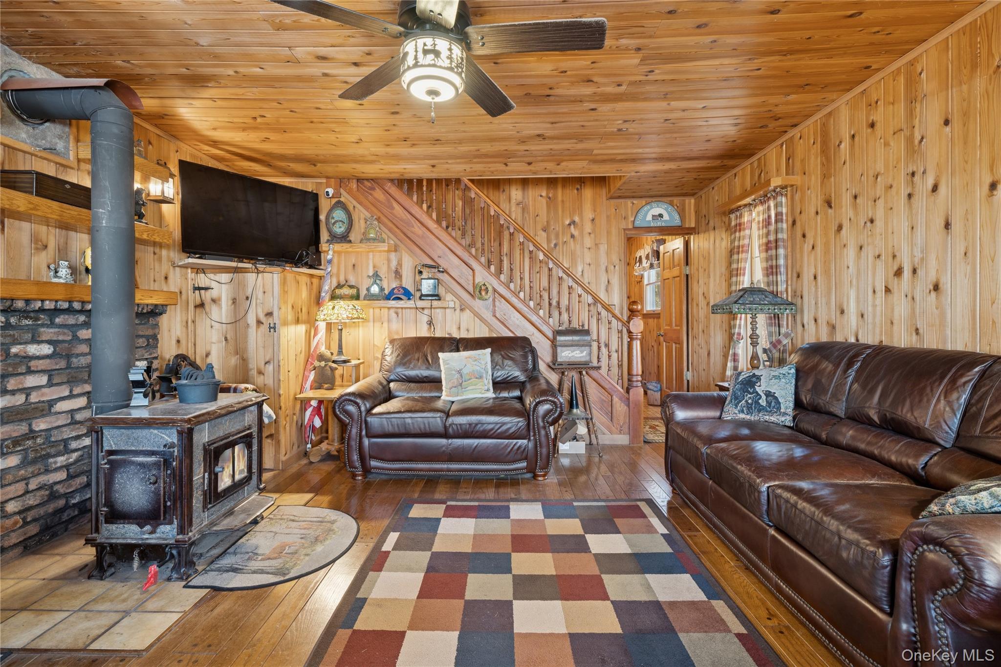 37 Nober Strunk Road Narrowsburg, NY 12764 - Photo 18 of 50 a living room with furniture a flat screen tv and a dining table