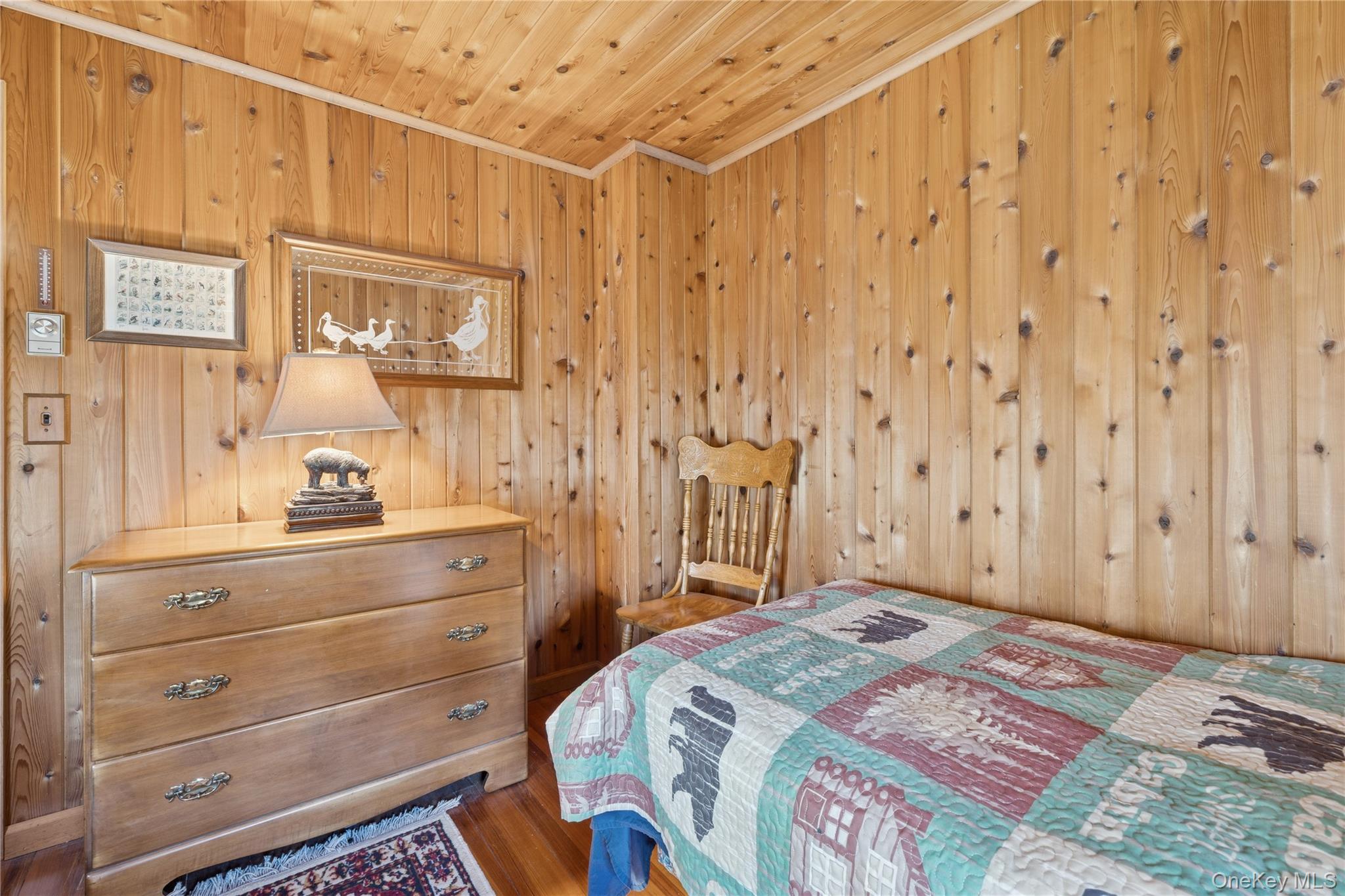 37 Nober Strunk Road Narrowsburg, NY 12764 - Photo 25 of 50 a bedroom with a bed and a cabinets