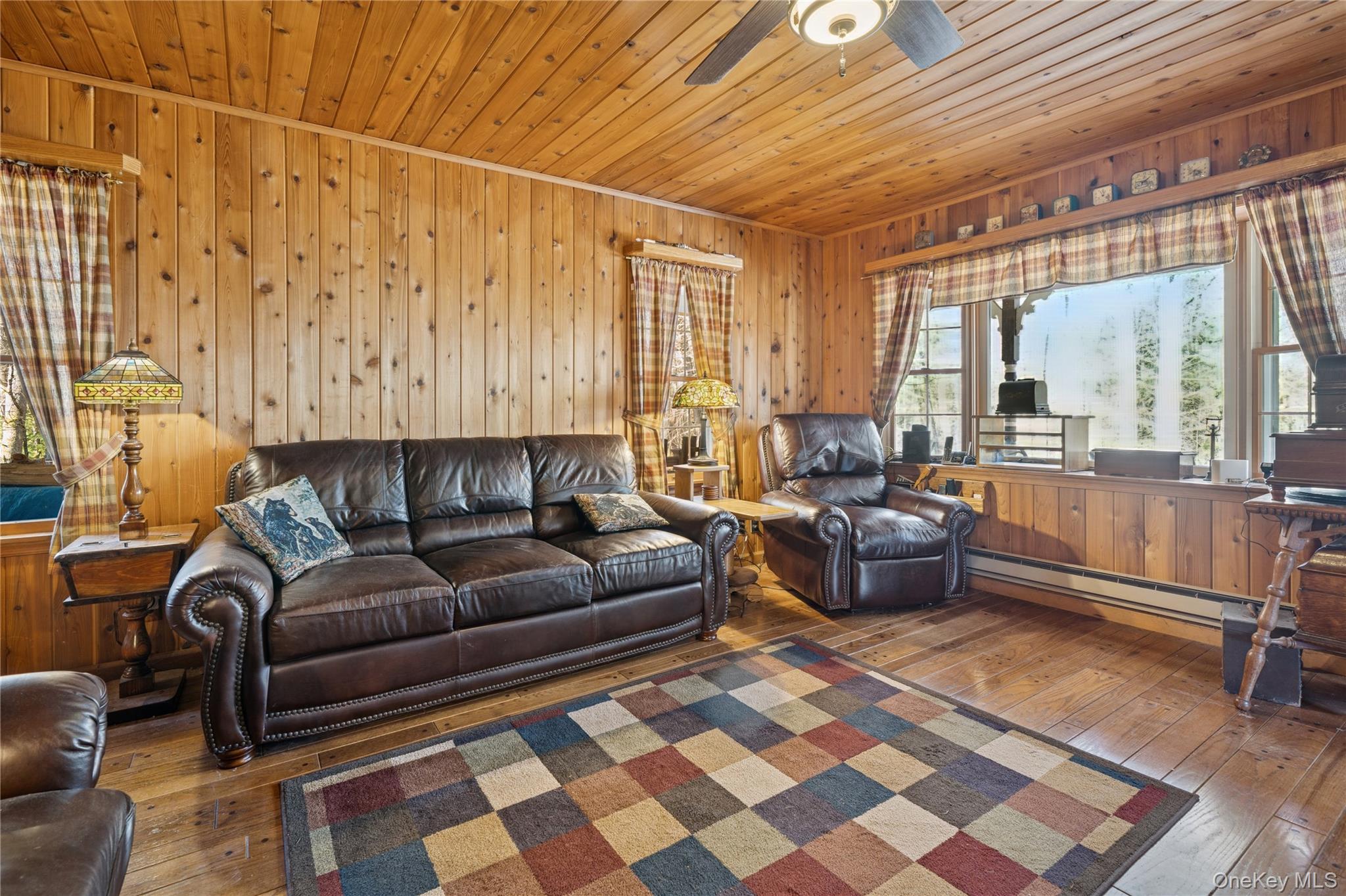 37 Nober Strunk Road Narrowsburg, NY 12764 - Photo 6 of 50 a living room with a couch and a dining table with wooden floor