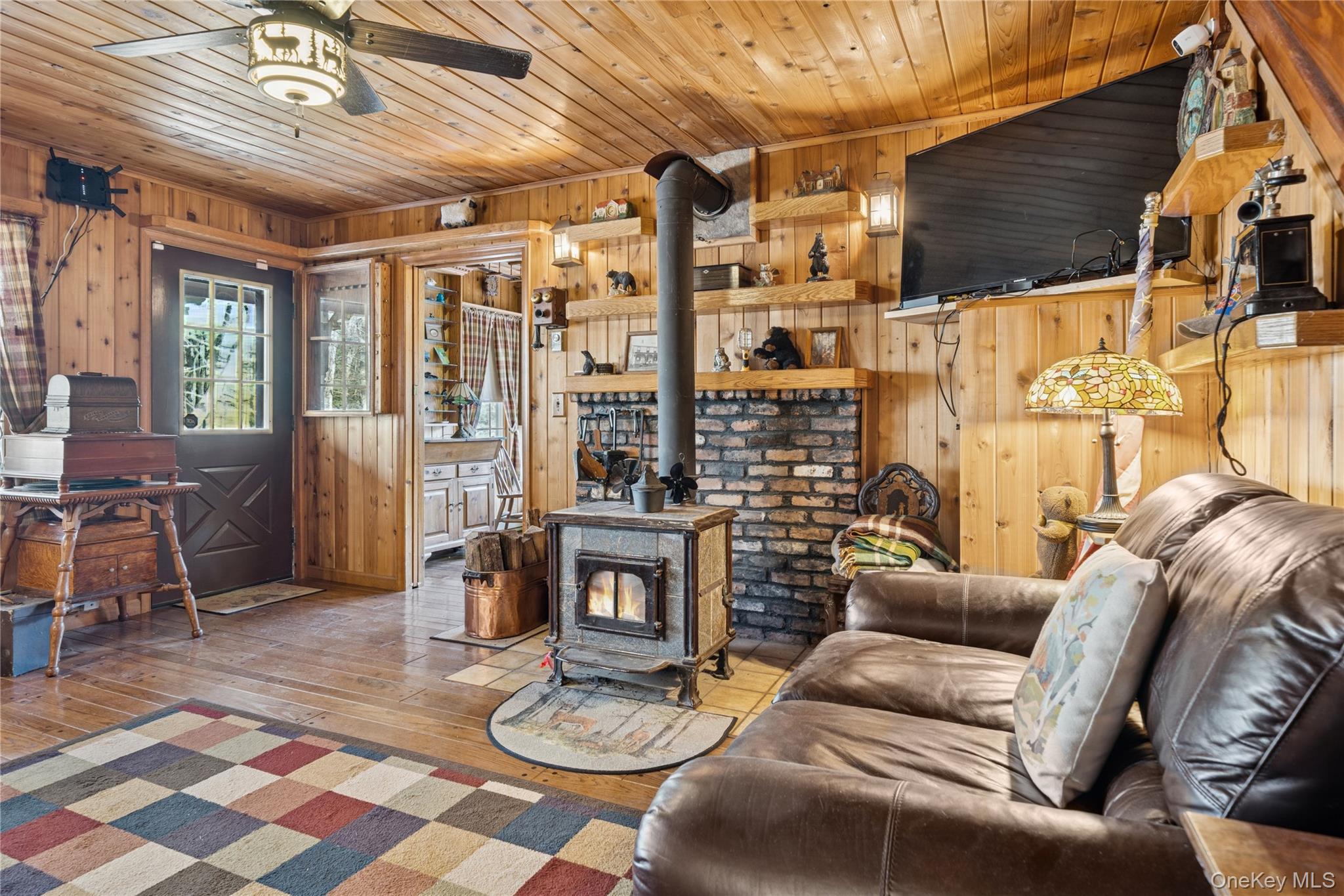 37 Nober Strunk Road Narrowsburg, NY 12764 - Photo 7 of 50 a living room with furniture a fireplace and a dining table