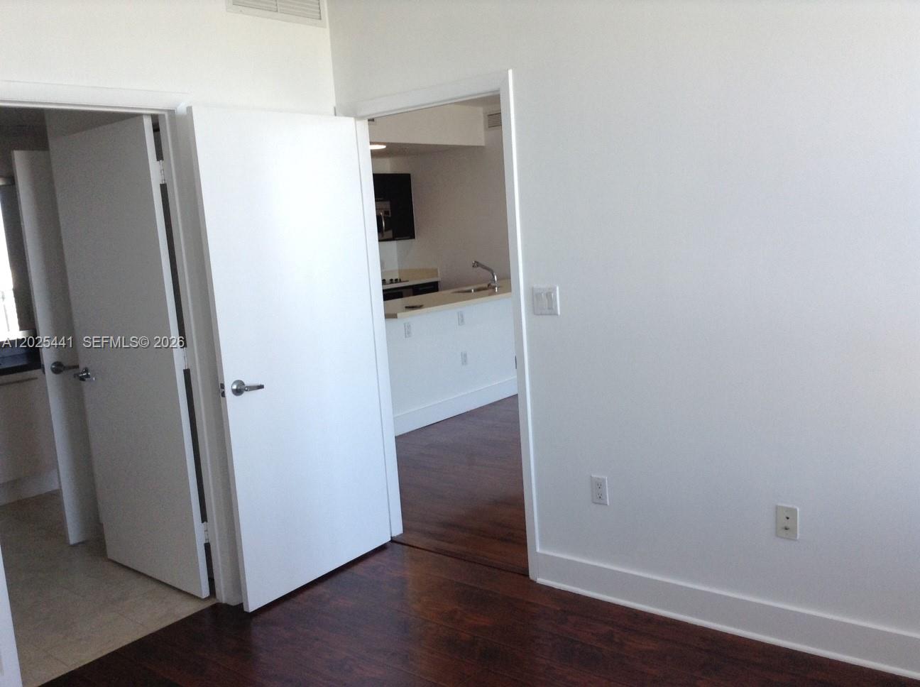 90 Southwest 3rd Street, Unit 3708 Miami, FL 33130 - Photo 9 of 13 an empty room with wooden floor and closet