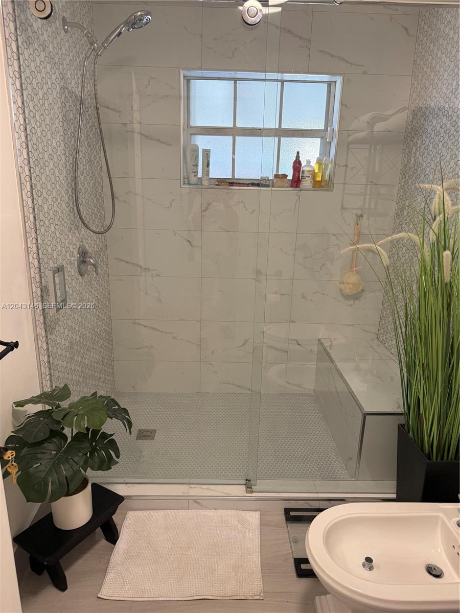 4947 Southwest 143rd Avenue Miami, FL 33175 - Photo 18 of 19 Master bathroom has a Kohler bidet, toilet, and seating in shower.