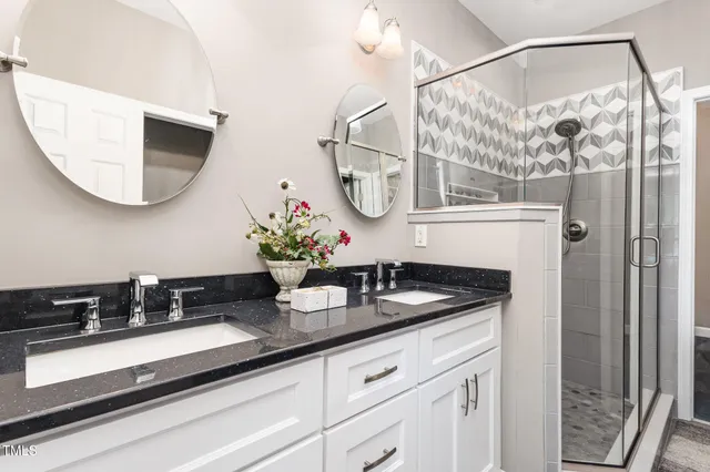 a bathroom with a granite countertop sink a mirror and vanity