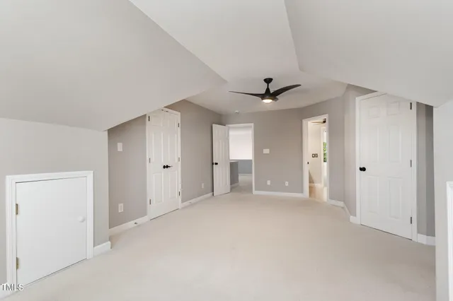 a view of empty room with ceiling fan