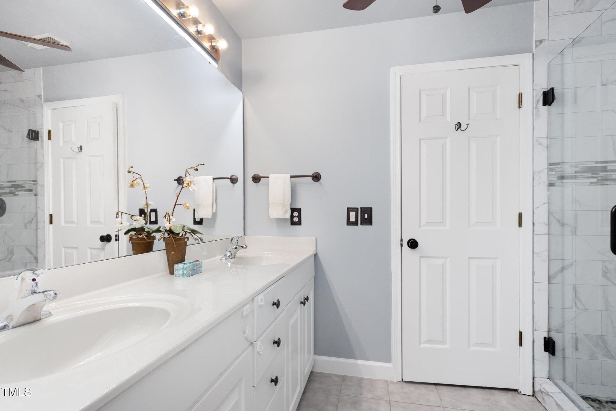 8004 Thrush Ridge Lane Raleigh, NC 27615 - Photo 24 of 34 a bathroom with double vanity sink and a mirror