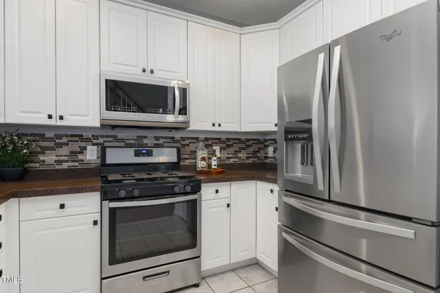 a kitchen with cabinets stainless steel appliances and a counter space