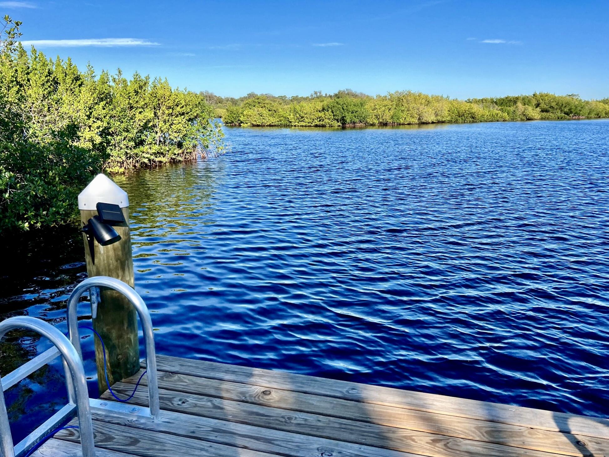 34 Sunset Drive Sebastian, FL 32958 - Photo 25 of 63 a view of a lake with a house in the background
