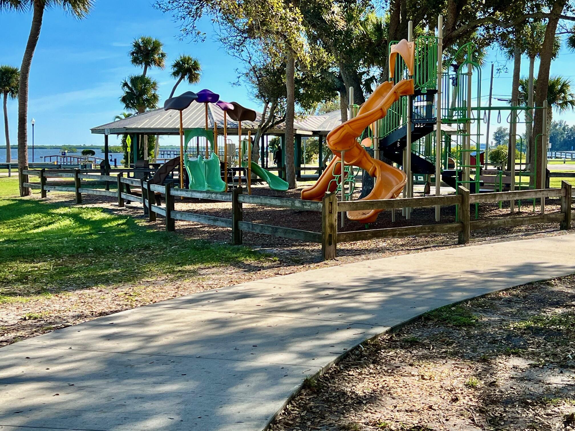 34 Sunset Drive Sebastian, FL 32958 - Photo 52 of 63 a view of a park with swings and slides