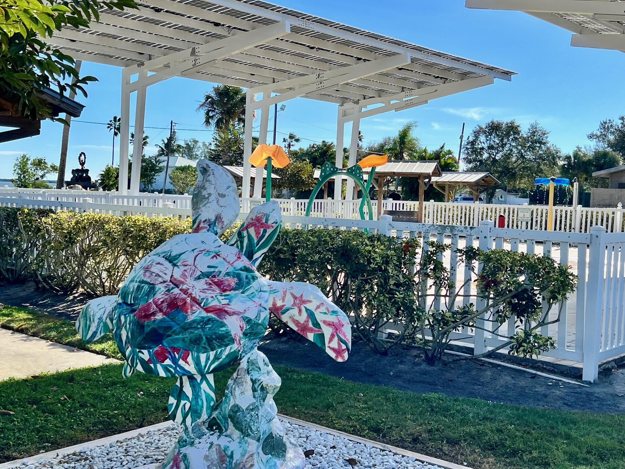 34 Sunset Drive Sebastian, FL 32958 - Photo 53 of 63 a group of people sitting in a yard in front of retail shops